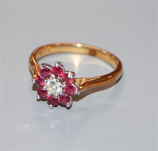 A modern 18ct gold, ruby and diamond flowerhead cluster ring, size O.